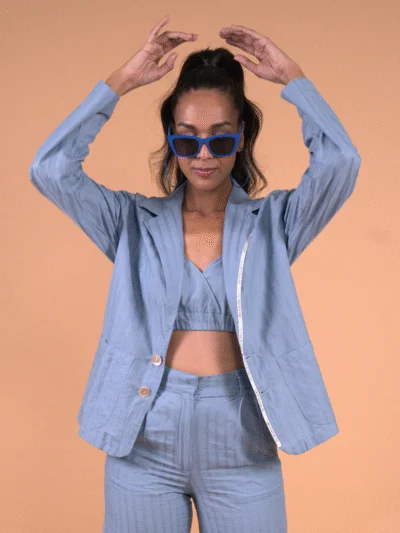 Woman wearing blue co-ord blazer set with sunglasses
